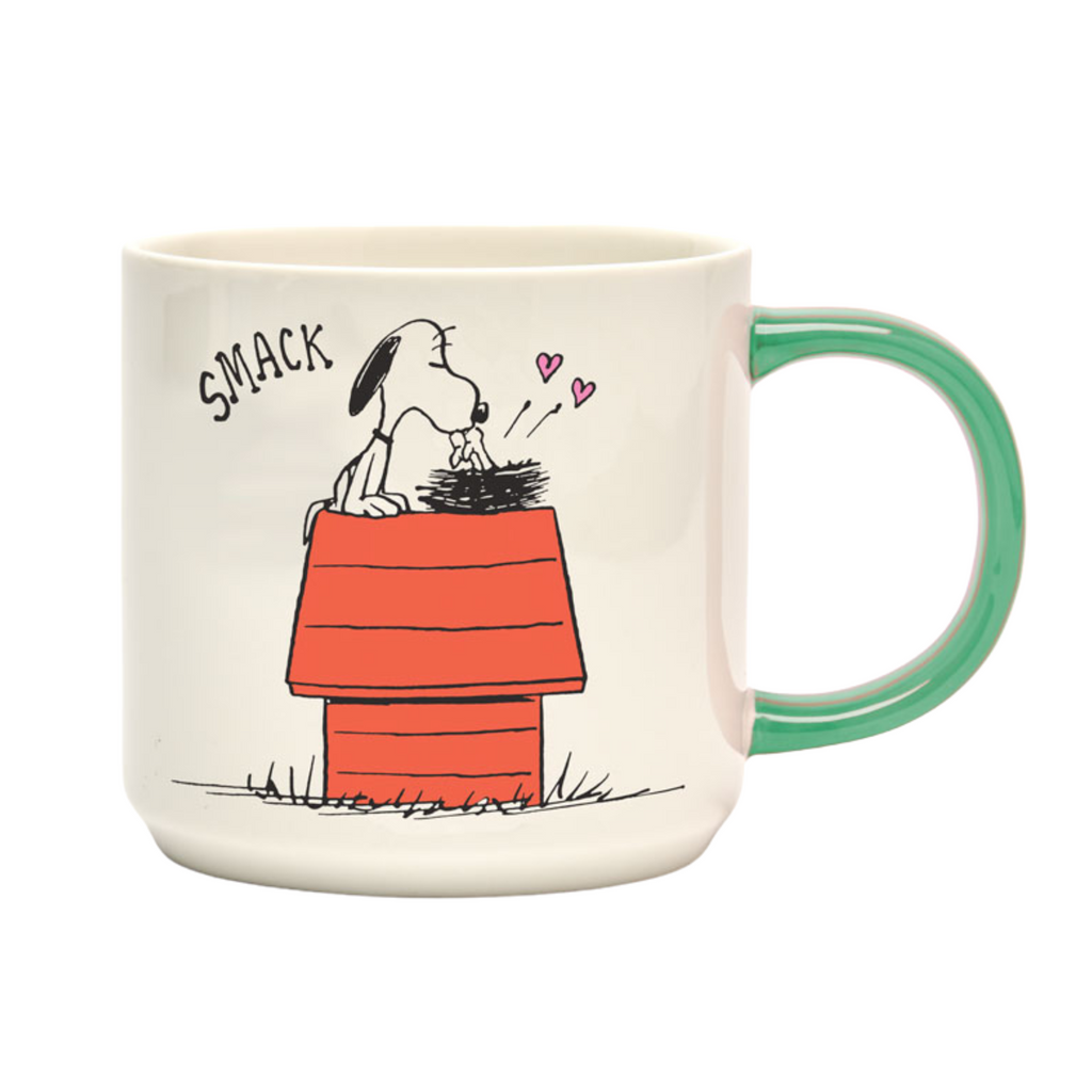 PEANUTS-themed mug with green handle featuring Snoopy kissing Woodstock on a red doghouse with “SMACK” text and pink hearts — a sweet, nostalgic design for Snoopy lovers.
