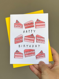Happy birthday card with hand-drawn slices of pink strawberry cake with strawberries on top, arranged around the words ‘Happy Birthday,’ paired with bright yellow envelope.
