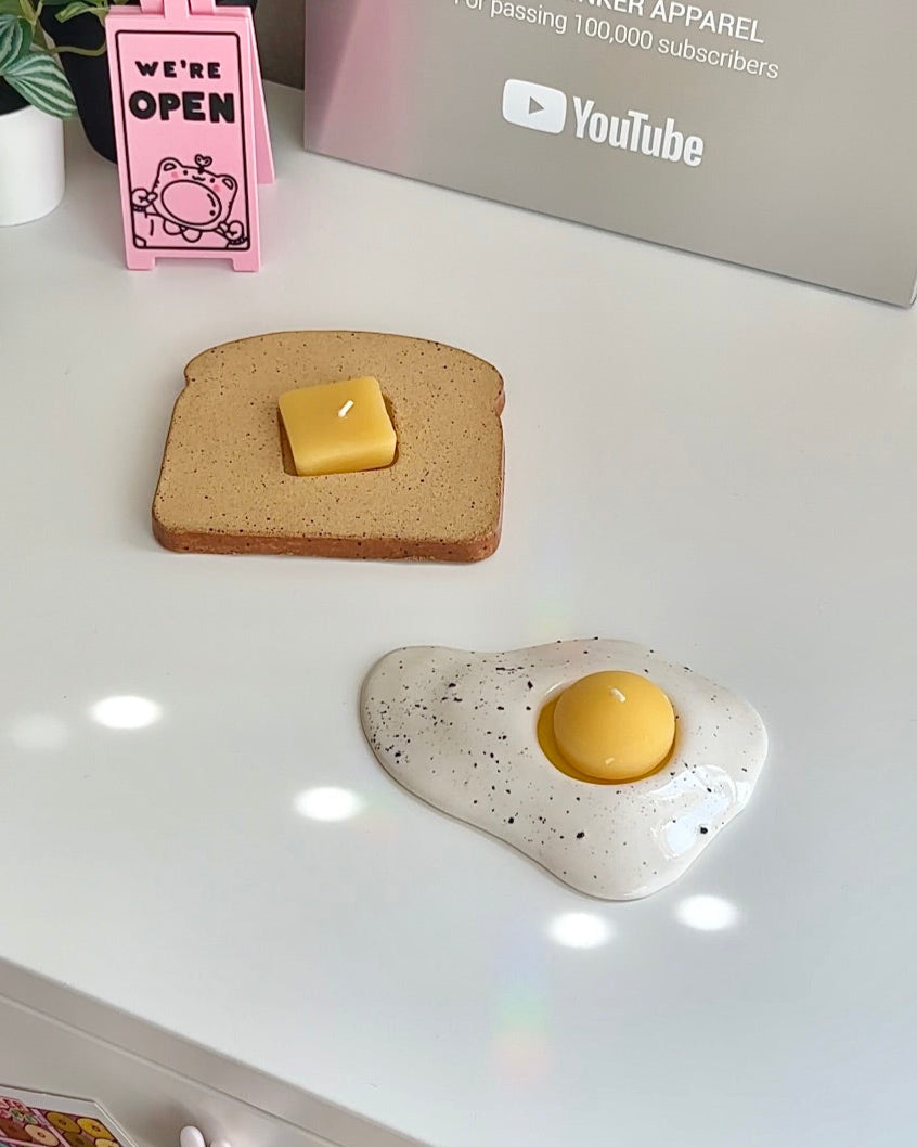 Toast and egg candle holders styled together as a quirky breakfast-themed decor set