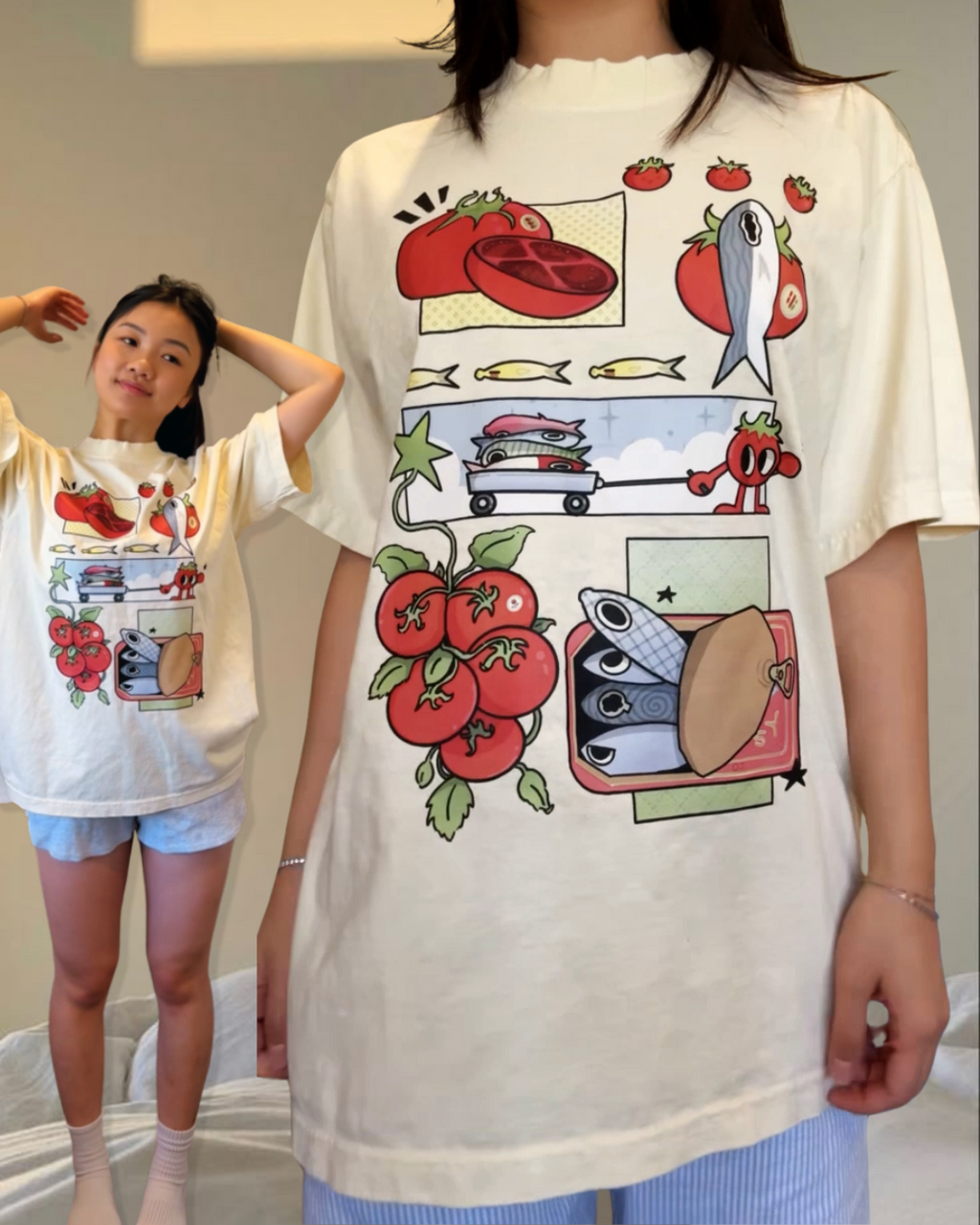 Ivory graphic t-shirt featuring comic-style panels of tomatoes, sardines, and playful food illustrations
