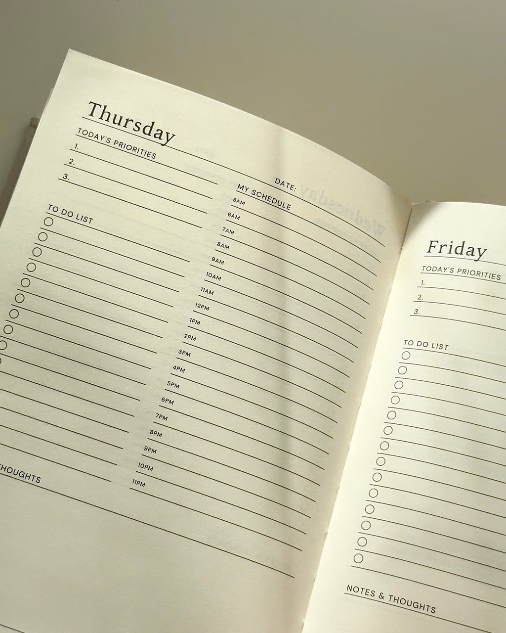 Undated daily planner interior showing hourly schedule, priorities, and to-do list layout designed for structured yet gentle daily planning.