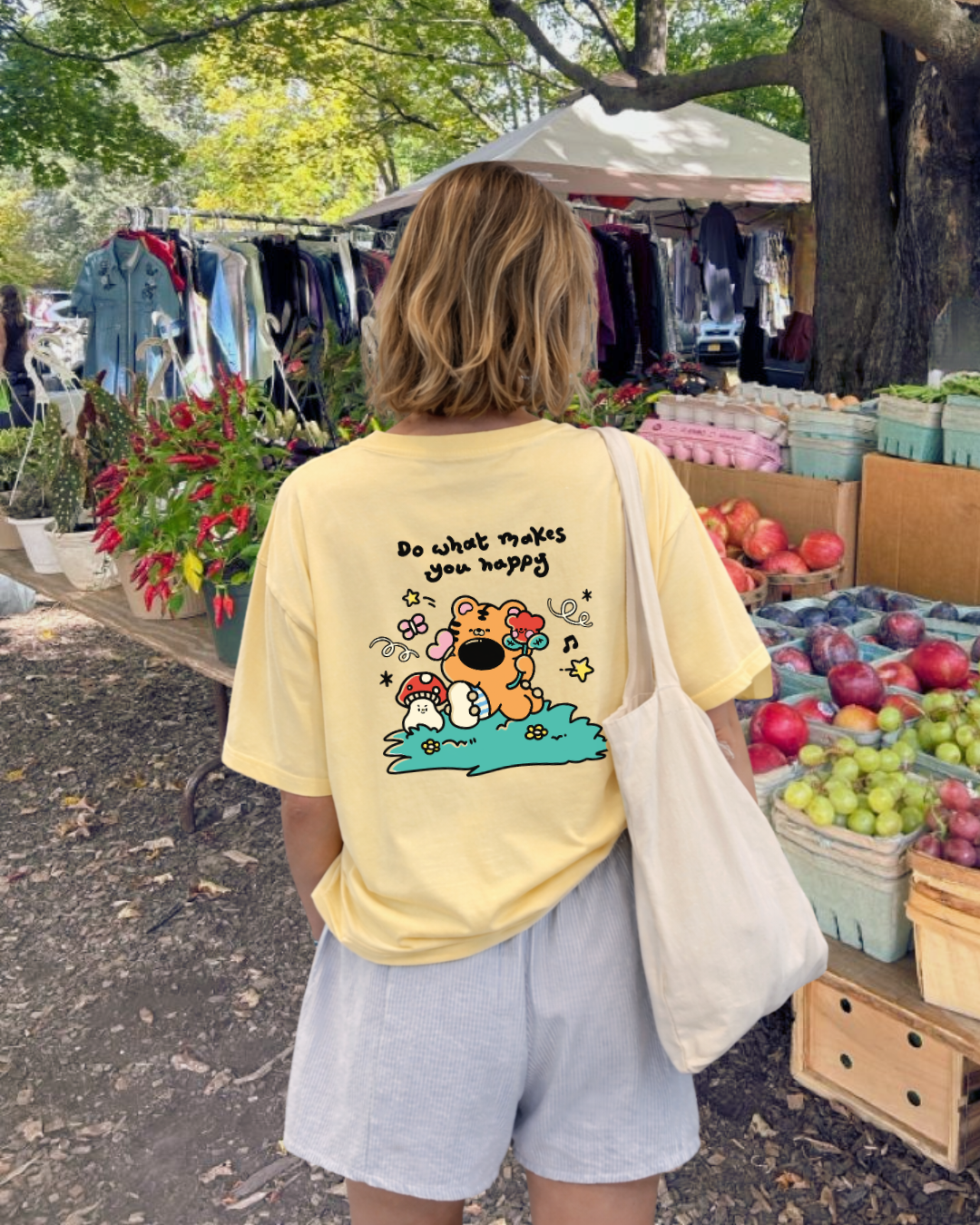 Yellow t shirt with saying “Do What Makes You Happy” and cute tiger illustration on back, positive graphic tee for women.