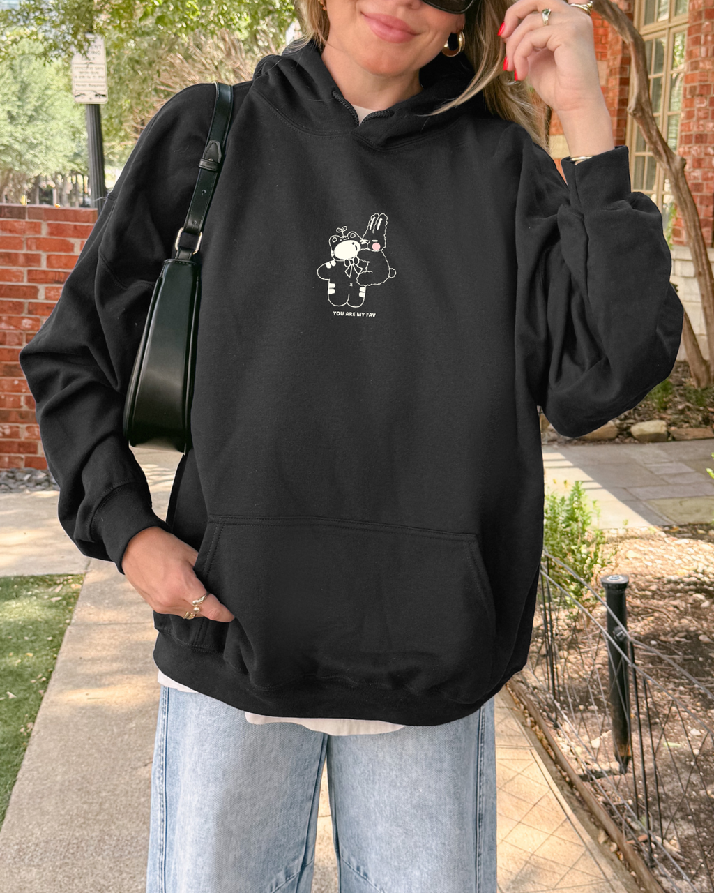 Casual street-style look featuring a black minimal hoodie with a small embroidered “You Are My Fav” message