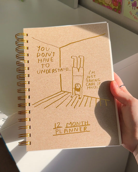 Self-care growth planner with kraft cover and guided reflections